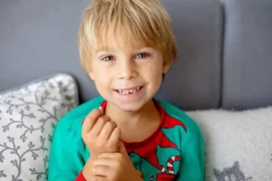 Smiling child with stress free tooth extraction in Spirit Lake, IA