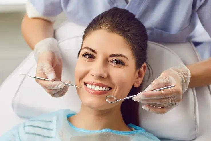 Patient smiling during dental exam, representing comfortable dental care in Spirit Lake, IA