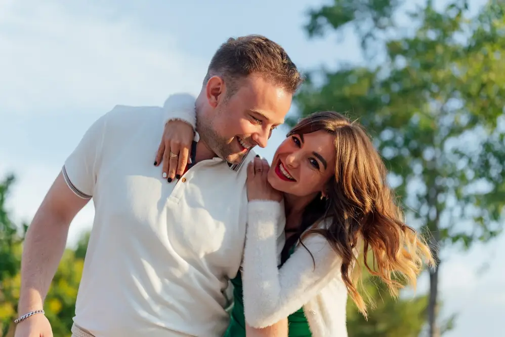 Happy couple smiling outdoors, representing confident smiles with Preventive Dentistry